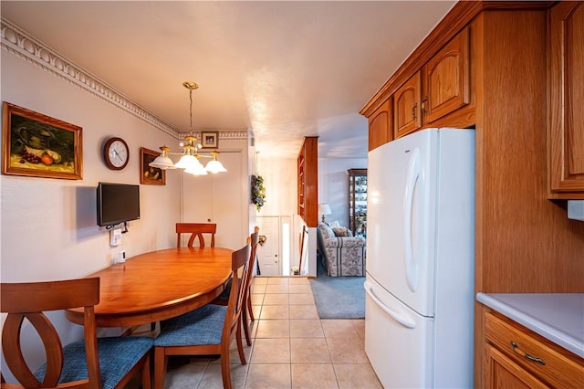 dining room with light tile patterned floors and a notable chandelier