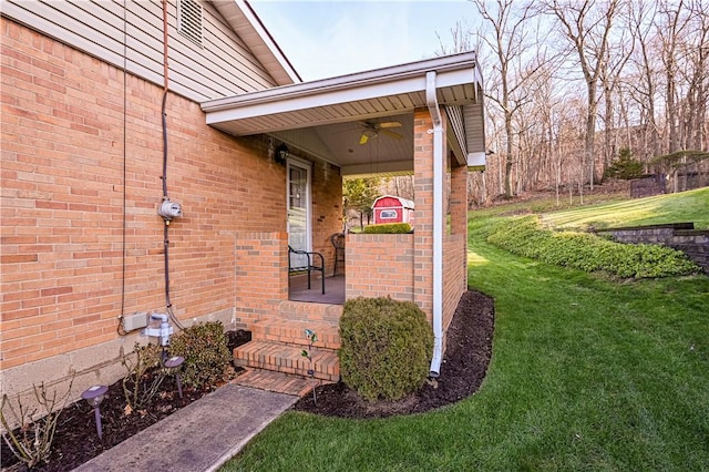 exterior space featuring a lawn and ceiling fan