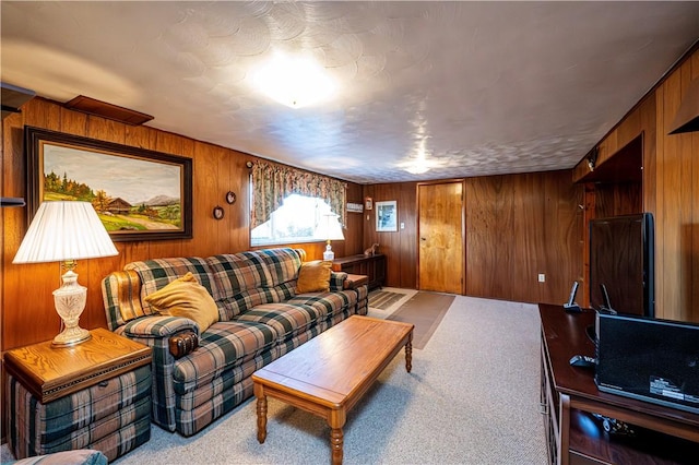 living room featuring carpet floors and wood walls