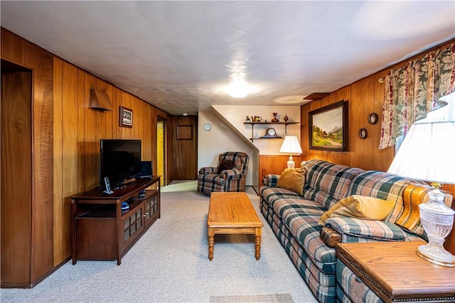 living room featuring wooden walls and light colored carpet