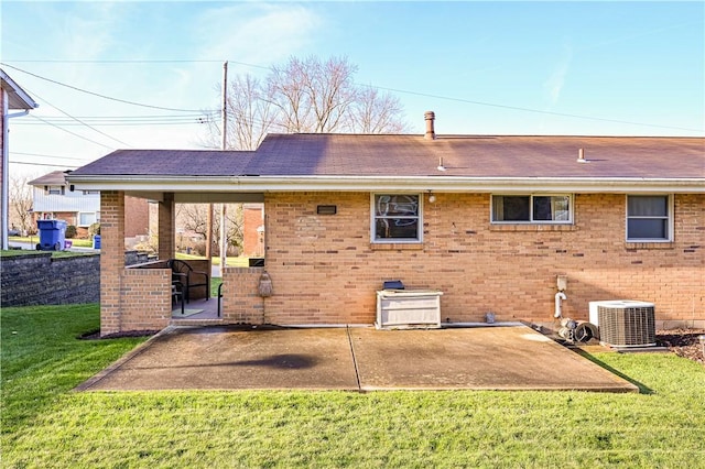 back of house with a lawn, central AC, and a patio