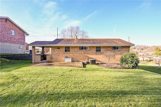 back of property featuring a yard, a patio, and central AC