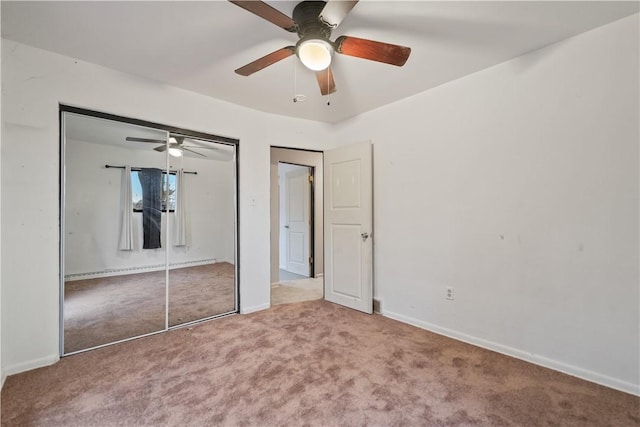 unfurnished bedroom featuring ceiling fan, carpet floors, and a closet