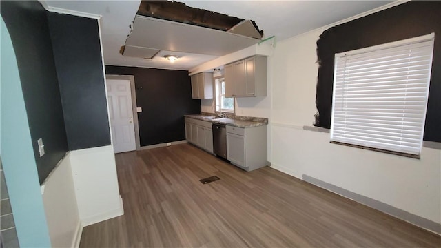 kitchen featuring stainless steel dishwasher, dark hardwood / wood-style flooring, gray cabinetry, and sink