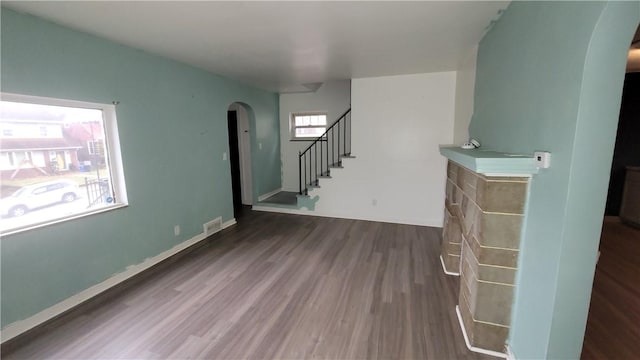 1802 Alcoa Dr, Arnold, PA 15068 - unfurnished living room with arched walkways, wood finished floors, and stairway