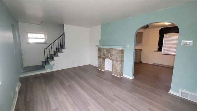 1802 Alcoa Dr, Arnold, PA 15068 - unfurnished living room featuring dark wood-style floors, arched walkways, and stairway