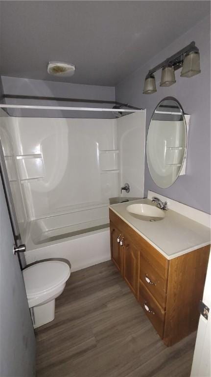 full bathroom featuring hardwood / wood-style floors, vanity, toilet, and tub / shower combination