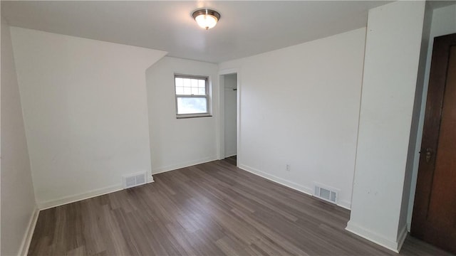 empty room with dark wood-type flooring