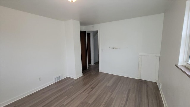 unfurnished room with dark hardwood / wood-style floors