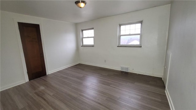 unfurnished room with dark hardwood / wood-style floors