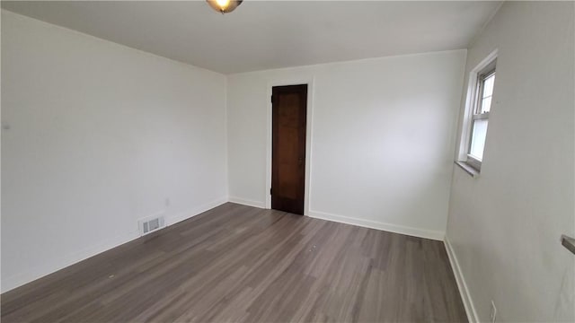 spare room featuring dark hardwood / wood-style flooring