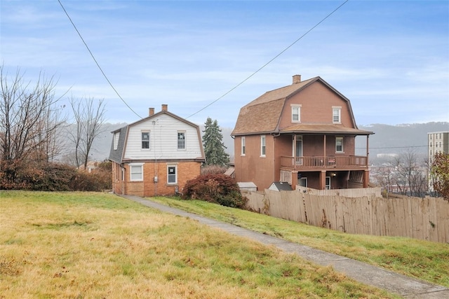 rear view of house with a yard