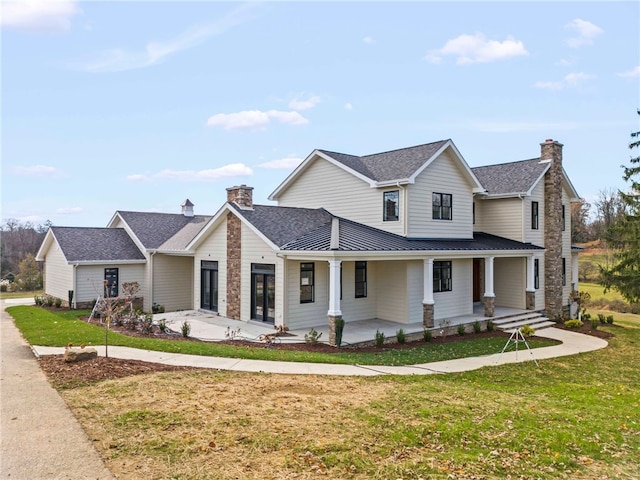 view of front of property with a front yard and covered porch