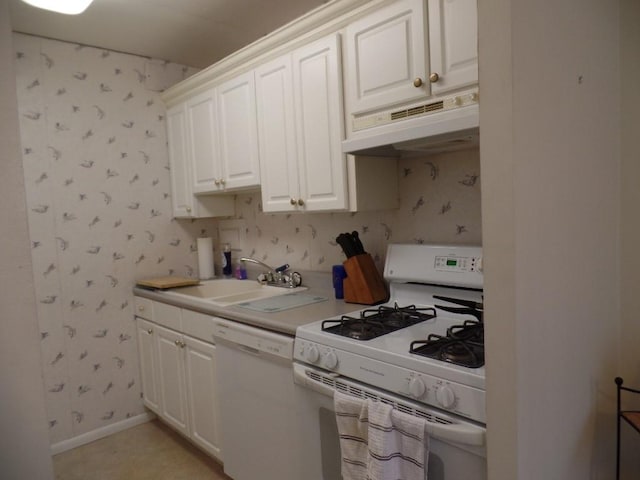 kitchen with white appliances, white cabinetry, and sink