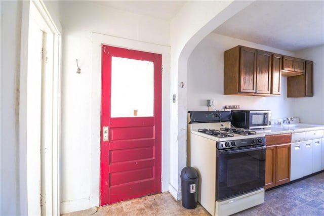 kitchen with sink and white gas range oven