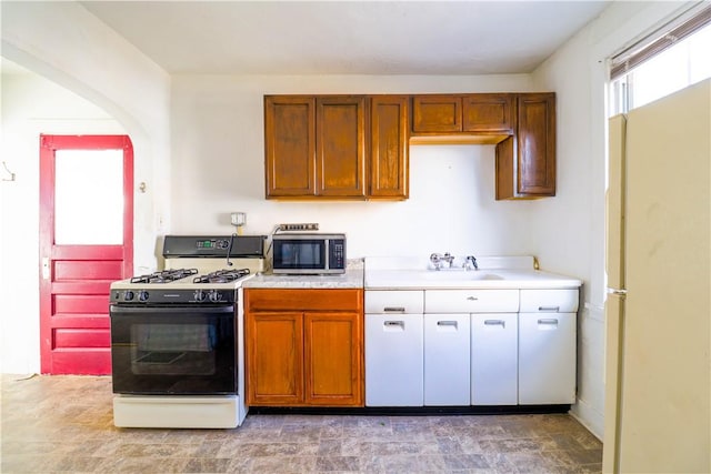 kitchen with white range with gas stovetop