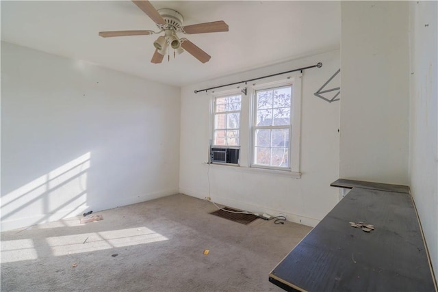 empty room featuring ceiling fan, cooling unit, and light carpet