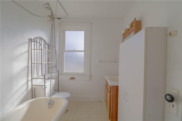 bathroom featuring vanity, toilet, and a tub