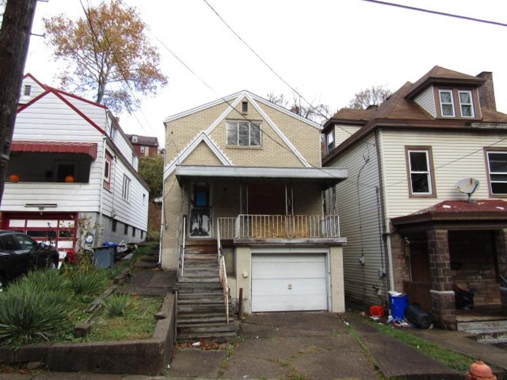 view of front facade with covered porch and a garage