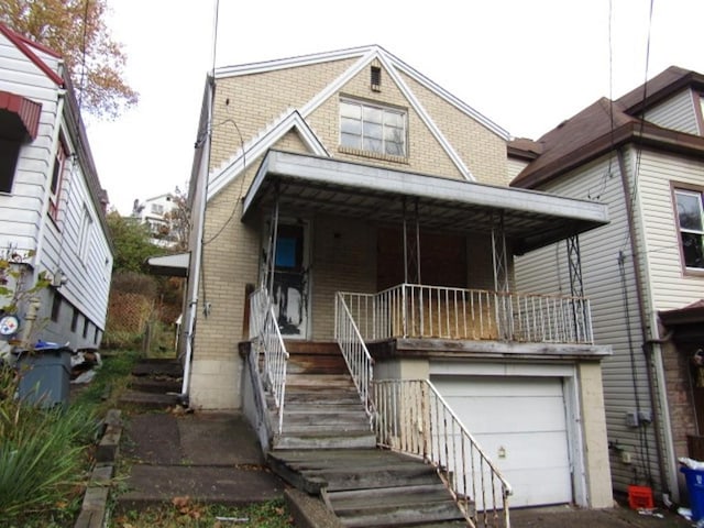 view of front of property with covered porch and a garage