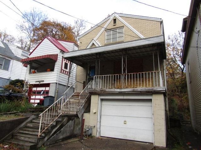 view of front of home with covered porch and a garage