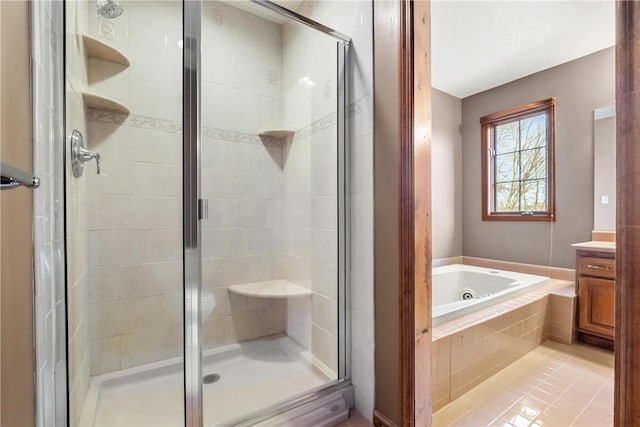 bathroom with tile patterned flooring, vanity, and shower with separate bathtub