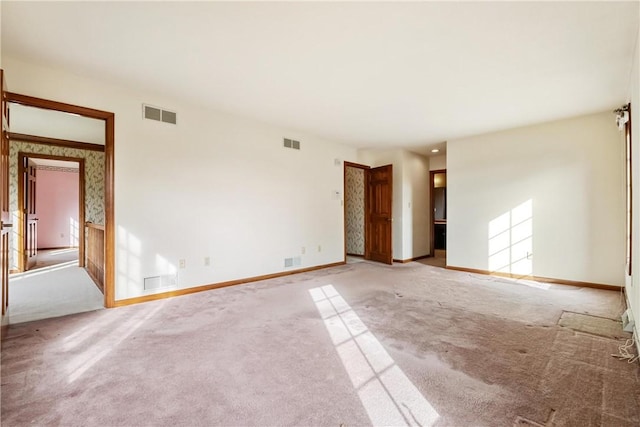 spare room with light colored carpet