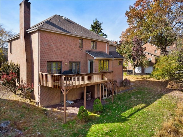 rear view of house with a yard, a deck, and central AC unit