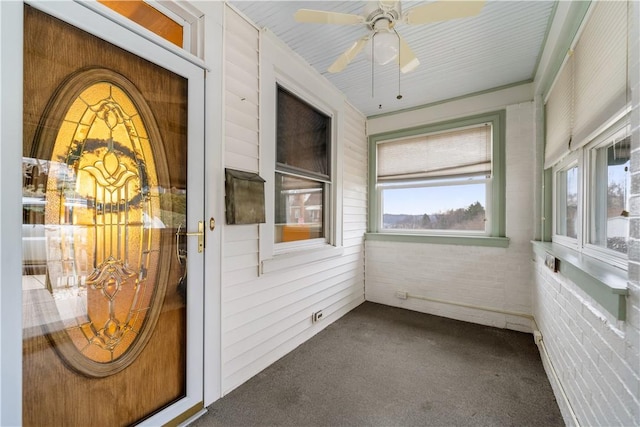 unfurnished sunroom featuring ceiling fan