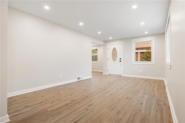 foyer entrance with light wood-type flooring