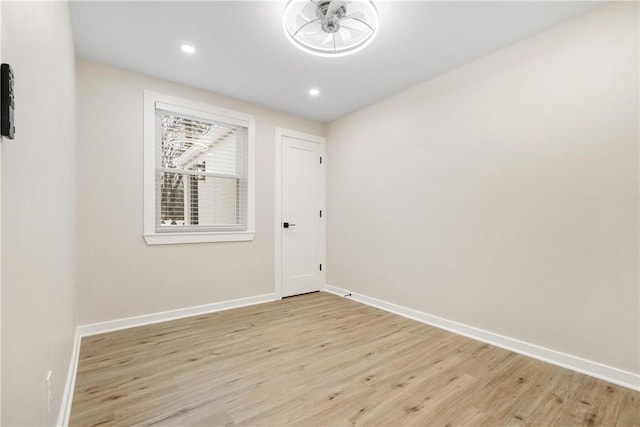 unfurnished room with ceiling fan and light wood-type flooring