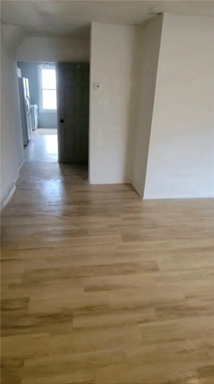 hallway with light hardwood / wood-style floors