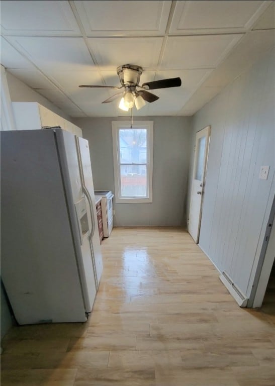 kitchen with ceiling fan, light hardwood / wood-style floors, and white fridge with ice dispenser