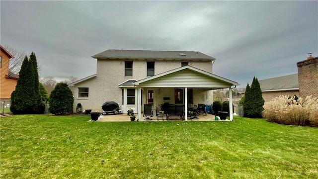 back of property featuring a lawn and a patio area