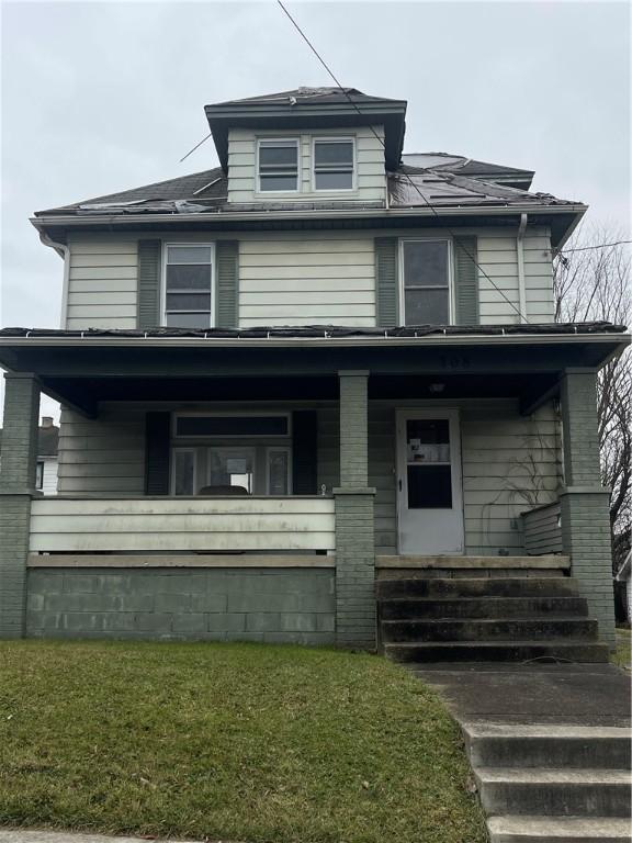 view of front property featuring a porch and a front lawn