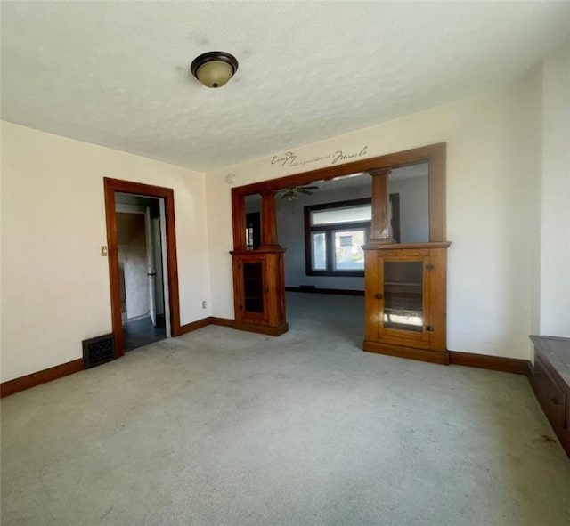 unfurnished living room with light colored carpet