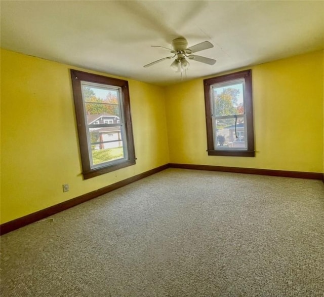 empty room featuring carpet floors and ceiling fan