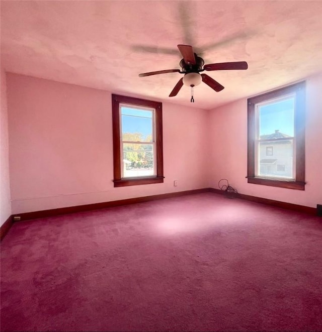 carpeted empty room featuring ceiling fan