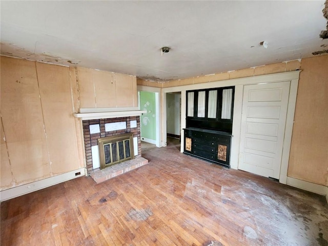 unfurnished living room with a fireplace and wood-type flooring