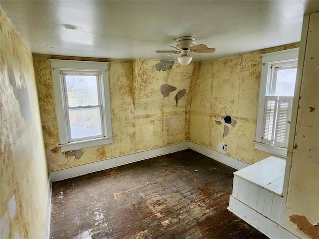 spare room with ceiling fan and dark wood-type flooring