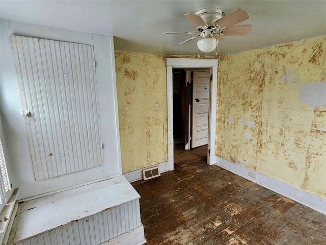 unfurnished room featuring ceiling fan and dark wood-type flooring