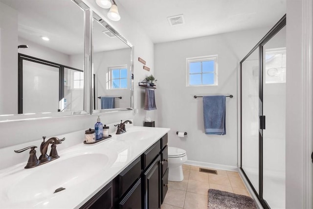 bathroom with tile patterned floors, vanity, toilet, and walk in shower