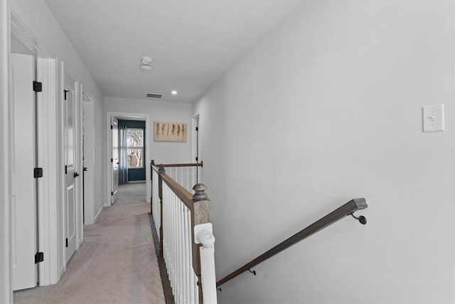 corridor with light colored carpet