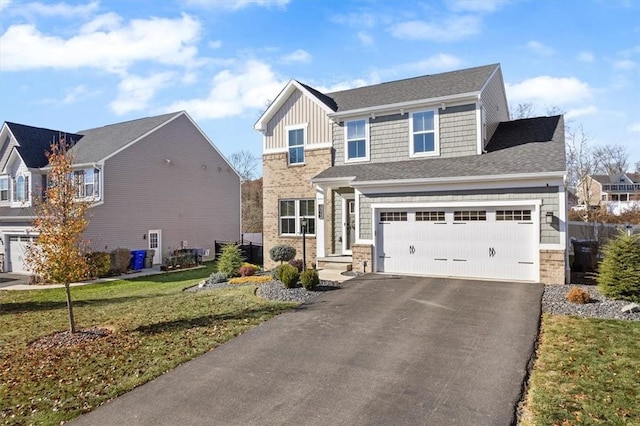 view of front of house featuring a front yard and a garage