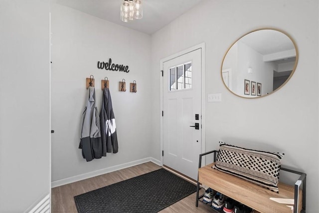 interior space with wood-type flooring and an inviting chandelier