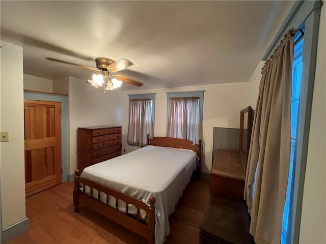 bedroom with ceiling fan and wood-type flooring