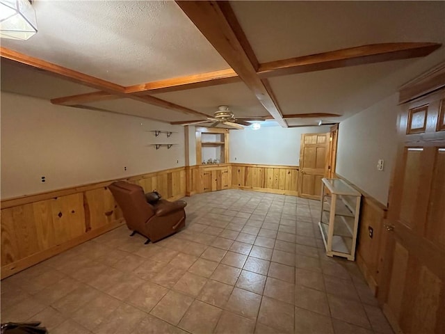 additional living space featuring beamed ceiling, a textured ceiling, and ceiling fan