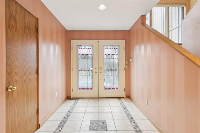 entryway with french doors and light tile patterned floors