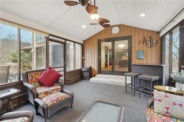 sunroom with ceiling fan, wood ceiling, and lofted ceiling