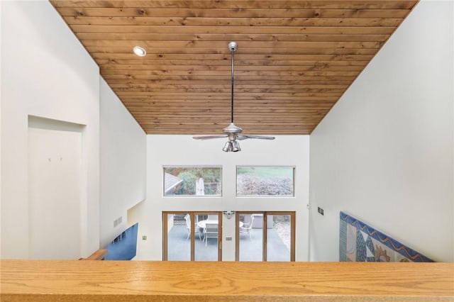 unfurnished living room featuring ceiling fan, high vaulted ceiling, and wood ceiling